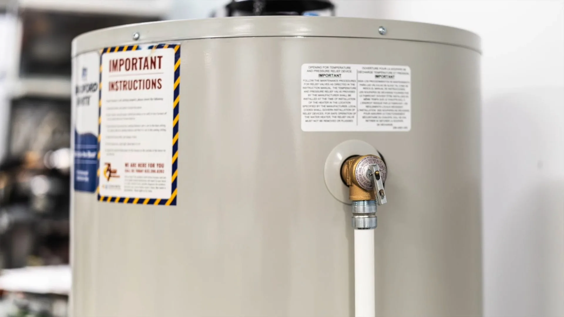 Brass temperature and pressure relief valve with a discharge pipe on the side of an electric water heater tank